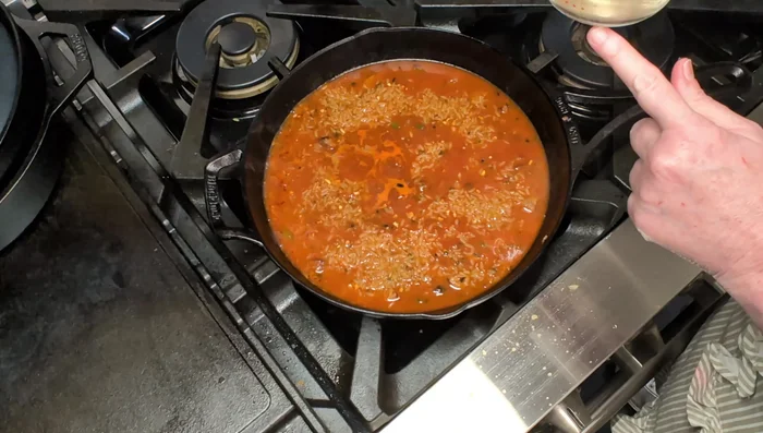 Add the rice and 3/4 cup of water to the skillet. Stir well to combine.