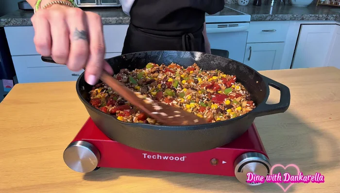 Stir in 1/2 cup of tomato sauce, 1 cup of uncooked rice, and additional smoked paprika, oregano, cracked black pepper, and salt.