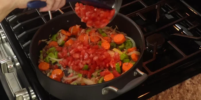 Add the tomatoes, poblano pepper, salt, pepper, and bay leaves. Stir well and cook for 15 minutes over low heat.