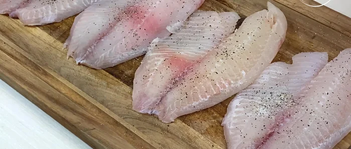 Season the tilapia fillets with salt and pepper on both sides.