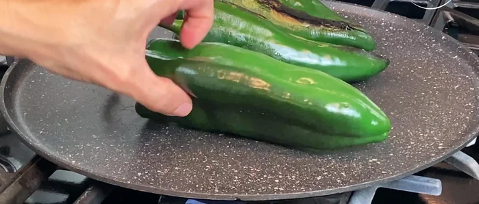 Grill the poblano chiles on a griddle at medium temperature for about 15 minutes. Place them in a plastic bag for 7 minutes to steam and make it easier to remove the skin.