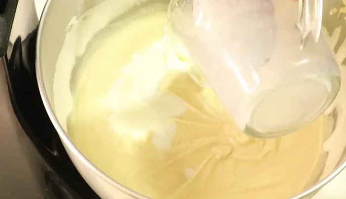 Add milk mixture: Gently fold in the curdled milk mixture.