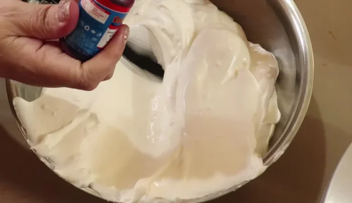 Assemble the cake: Once the cakes have cooled, level them if necessary. Brush with coffee liqueur. Layer with chantilly cream (divide and color some pink). Add chopped walnuts. Repeat layers. Decorate with remaining chantilly cream using different nozzles and colors.