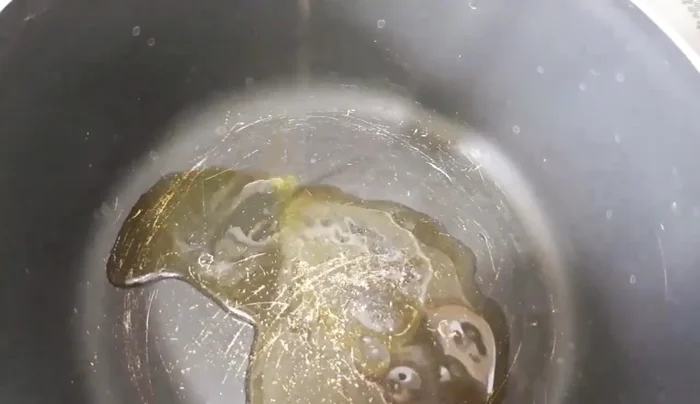 In a saucepan, heat about half a cup of olive oil. Add the blended garlic and onion mixture and fry.