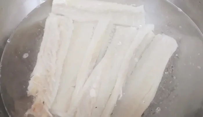 Remove salt from cod. Soak the cod in hot water for at least 1 day, changing the water every 2 hours to remove excess salt.