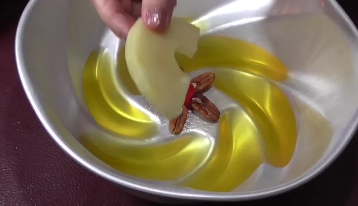 Add pineapple slices: Arrange pineapple slices on top of the walnuts.