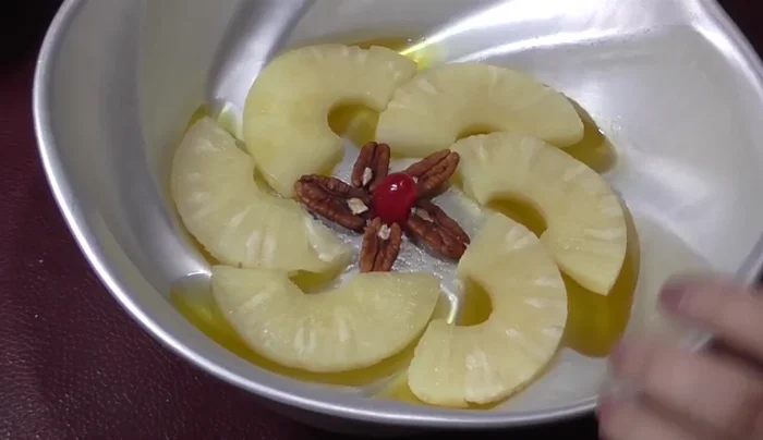Layer more gelatin: Carefully add more pineapple gelatin, ensuring it adheres to the walnuts.