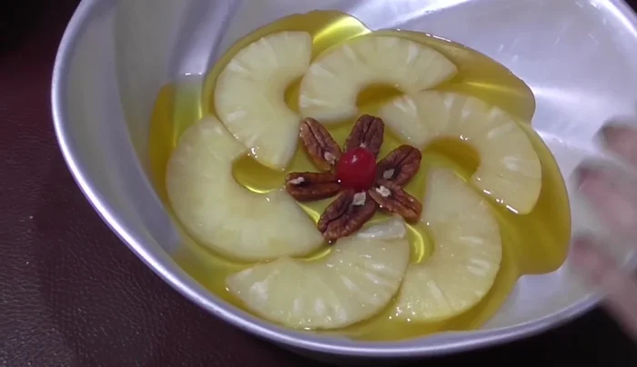Add remaining gelatin: Once set, add the remaining pineapple gelatin and refrigerate.