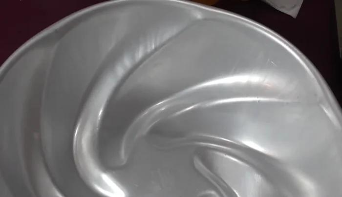 Layer the gelatin: Pour a small amount of the pineapple gelatin into the mold and freeze to set.