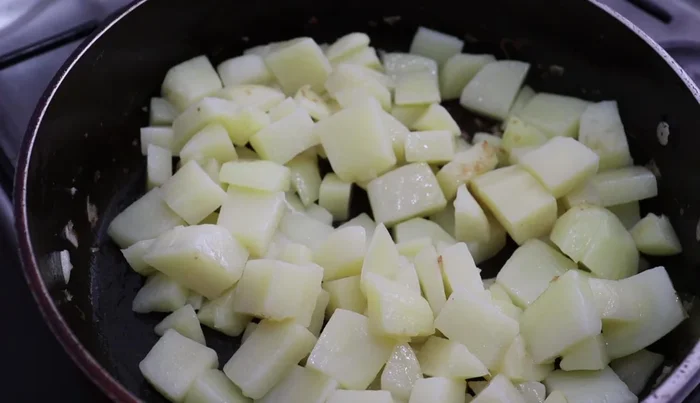 Add drained potatoes to the hot pan and cook until slightly changed color.