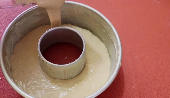 Pour batter into the prepared mold. Gently turn to remove air bubbles.