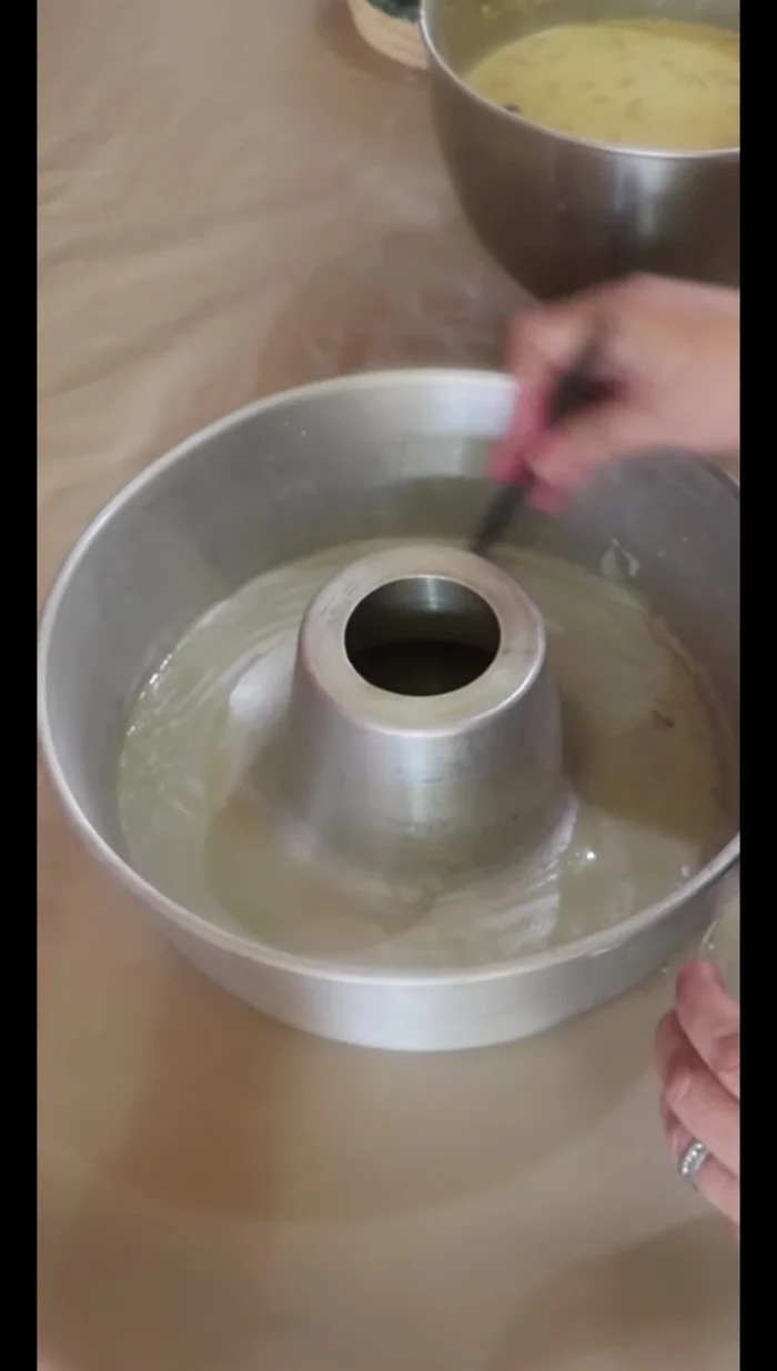 Grease and flour a baking pan. (281.479)