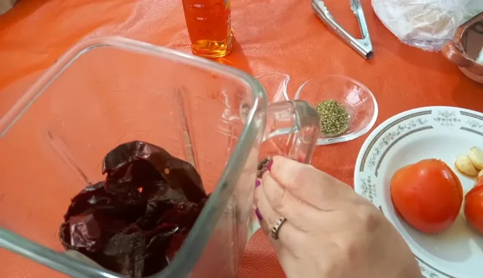 Blend the cooked chiles, garlic, tomatoes, oregano, remaining garlic cloves, peppers, and water until smooth.