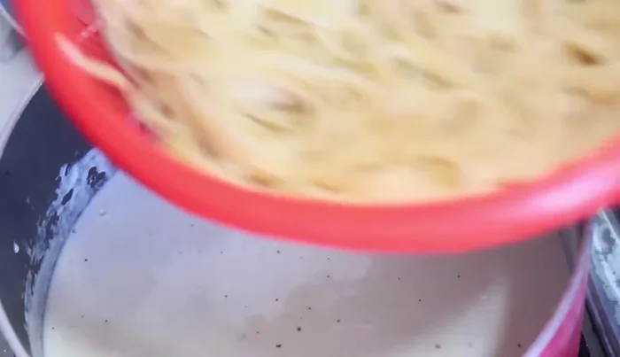 Add the cooked pasta and ham (cut into small squares) to the white sauce and stir to combine.