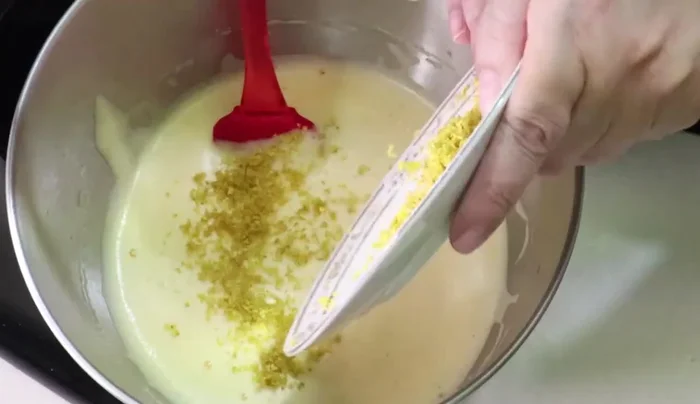 Add the orange zest, vanilla extract, and condensed milk. Beat for another minute at low speed.