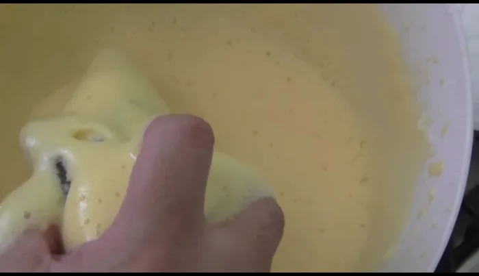 Fry the breaded peppers in a pan with oil over medium heat, turning frequently to prevent burning.