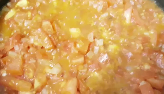 Add chopped tomatoes, tomato puree, consommé, water, and mushrooms to the pan. Simmer for a few minutes.