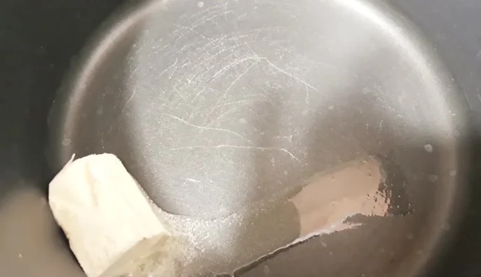 Melt butter in a separate saucepan. Add the cooked spaghetti and toss to coat.