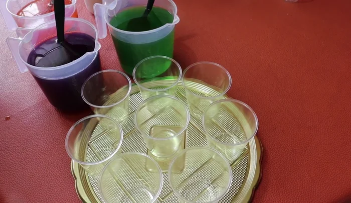 Layer the gelatins in individual cups or a large mold. Start with a layer of grape gelatin. Add another layer, and repeat the layering.