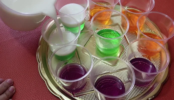 Add a layer of milk gelatin carefully to avoid mixing colors. Refrigerate to semi-set again.