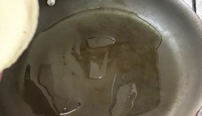 In another pan, heat oil and fry the tortillas until soft, not toasted.