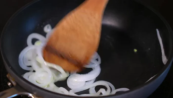 Add poblano strips to the onions, season generously with salt, and cook for 3-4 minutes until fragrant.