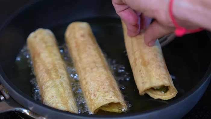 Fry tacos in hot oil, seam-side down, until golden brown on both sides.