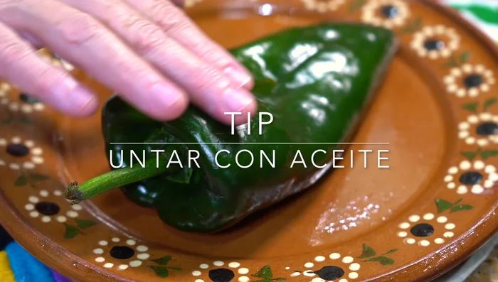 Roast poblano peppers, lightly oiled, until easily peeled. Let them sweat in a plastic bag (briefly).
