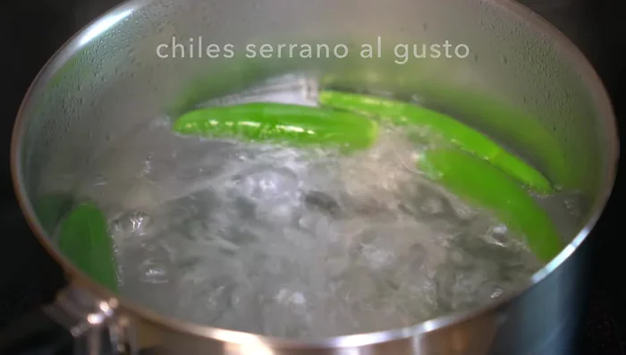 Prepare the pork rind filling: Cook green chilies, then add green tomatoes, onion, and garlic. Blend the cooled mixture with cilantro, salt, and a little water.