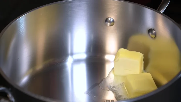 In a pan, melt butter and olive oil. Add chopped onion and cook for 5 minutes over medium heat.