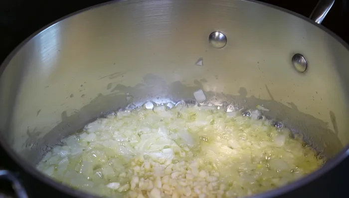 Add chopped garlic, oregano, and basil. Cook for 1 minute.