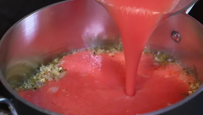 Pour in the blended tomatoes and simmer for 5 minutes over medium heat.