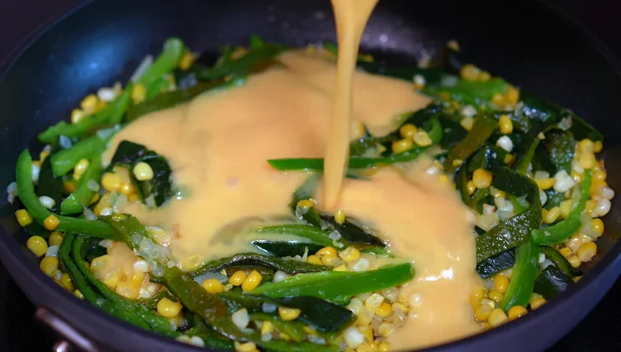 Add the beaten eggs and chopped cilantro to the pan with the poblanos. Gently incorporate them.