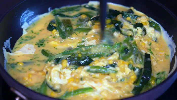 Add cubes of panela cheese and continue cooking until the eggs are set but still tender.