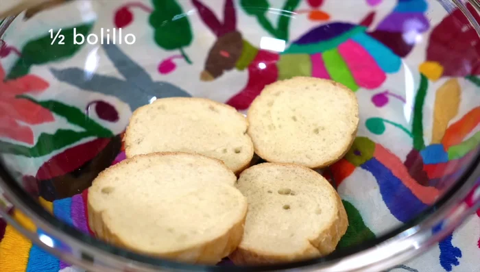 Hydrate half a bolillo roll with a little milk. This makes the meat juicy and soft. You can substitute with 1-2 slices of white bread.