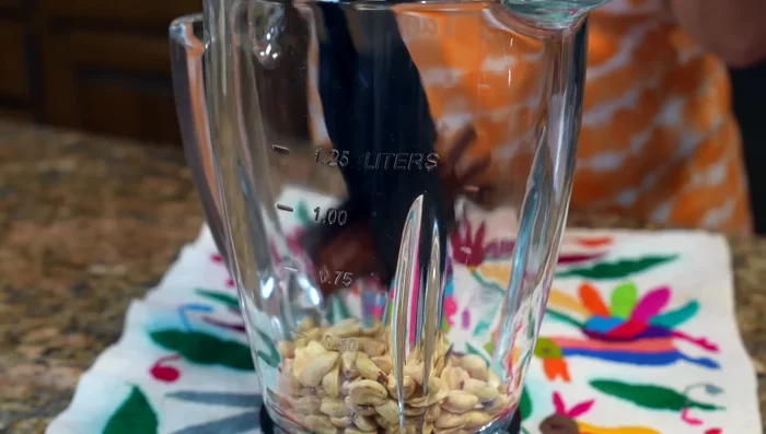 Blend the cooled peanuts, cinnamon water, milk, and evaporated milk until smooth.