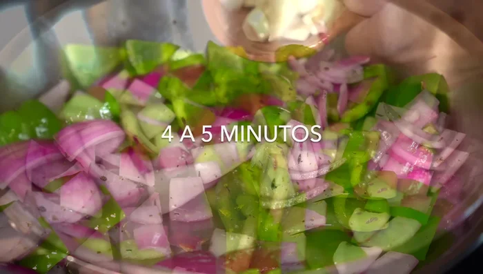 After 4-5 minutes, add 2 large garlic cloves, cut into pieces, and continue cooking.