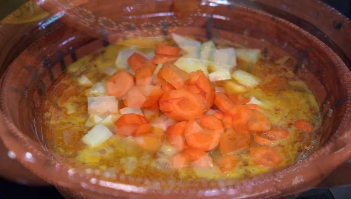 Add peeled and cubed potatoes and carrots (without soaking water). Season vegetables with salt if needed. Cover and cook for 30 minutes until vegetables are tender.