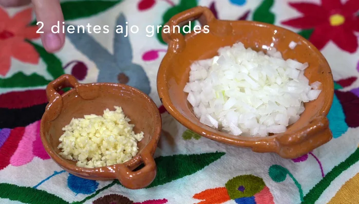 Finely chop garlic and onion. Place meat in a casserole dish with a little water. Add chopped garlic.