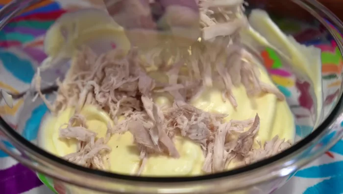 Add shredded chicken to the egg mixture and mix.
