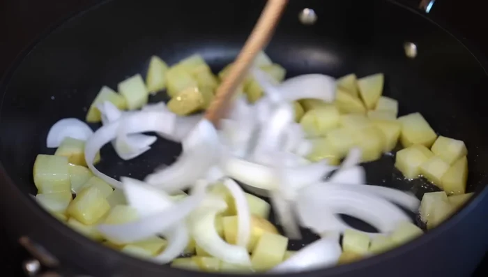 Add the blended sauce to the potatoes and onions. Simmer for 15 minutes until potatoes are cooked through.