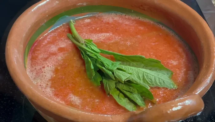 Add the epazote to the sauce and let it infuse its flavor.