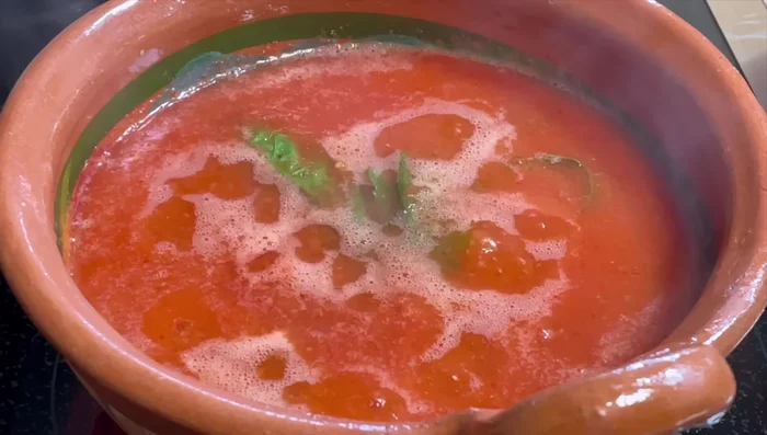 Add the eggs one by one to the simmering sauce. Add optional fresh cheese slices.