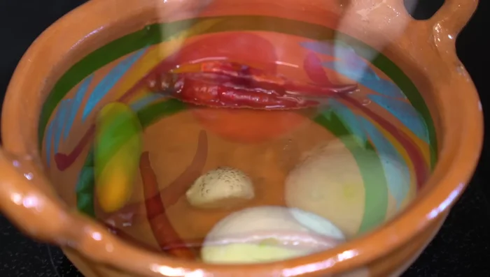 After 5 minutes, add the tomatoes (without stems) to the pot. Don't strain the sauce.