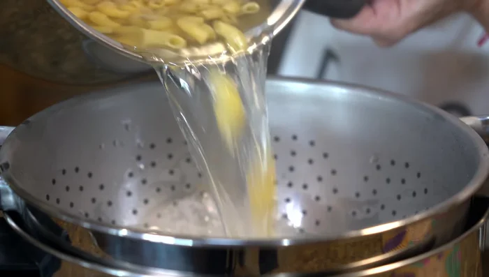 Drain the macaroni and reserve some cooking water.