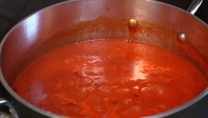 Add a little Parmesan cheese (optional) to the tomato sauce and let it melt; turn off heat.
