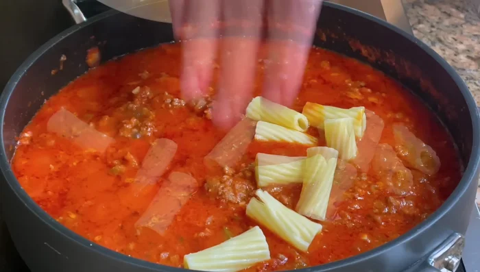 Add cooked pasta, stir well, and add a little pasta cooking water if needed.