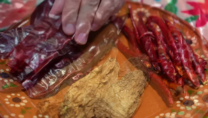 Clean and deseed guajillo chiles, chipotle chiles, and chiles de árbol.