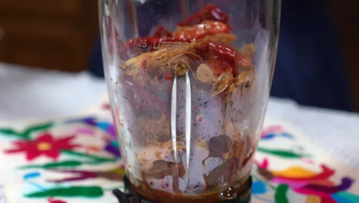 Blend sautéed chiles, tomatoes, shrimp heads, onion, garlic, and water until smooth. Strain the mixture.