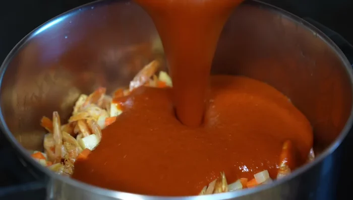 Add the blended chile sauce, stir well, lower the heat and simmer to allow flavors to blend.